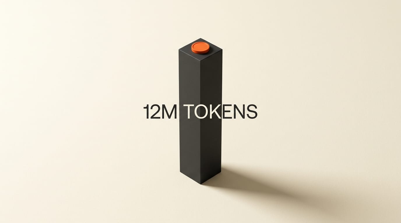Tall charcoal block with an orange disc cap visualizing a 12 million token context window.