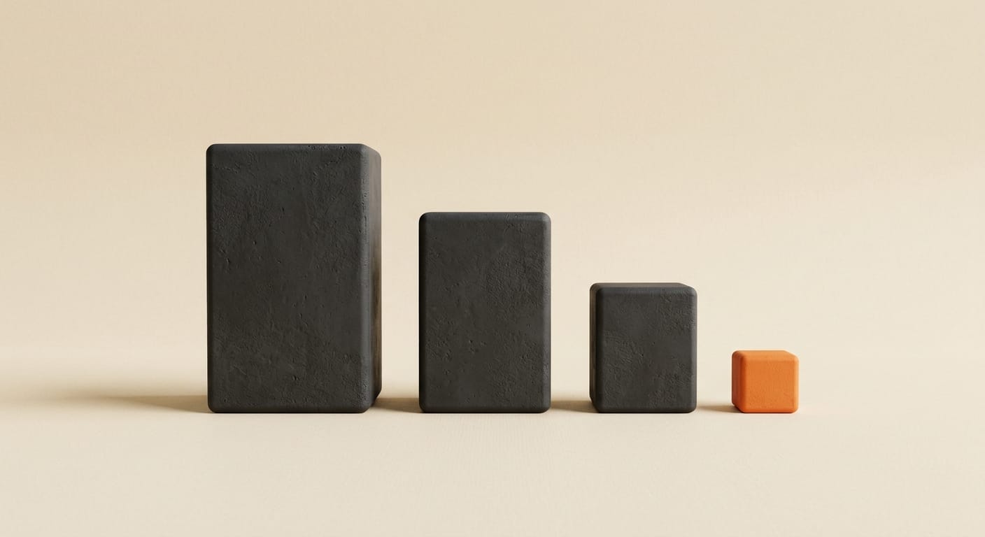 Three matte 3D coding model blocks of different sizes lined up for comparison